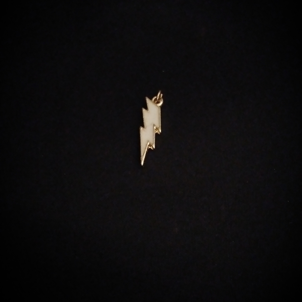 Enamel and gold tone white lightning pendant